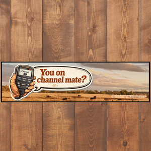Bumper sticker with a hand holding a phone and text 'You on channel mate?' on a wooden background
