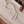 Pearl necklace on a wooden tray with decorative elements